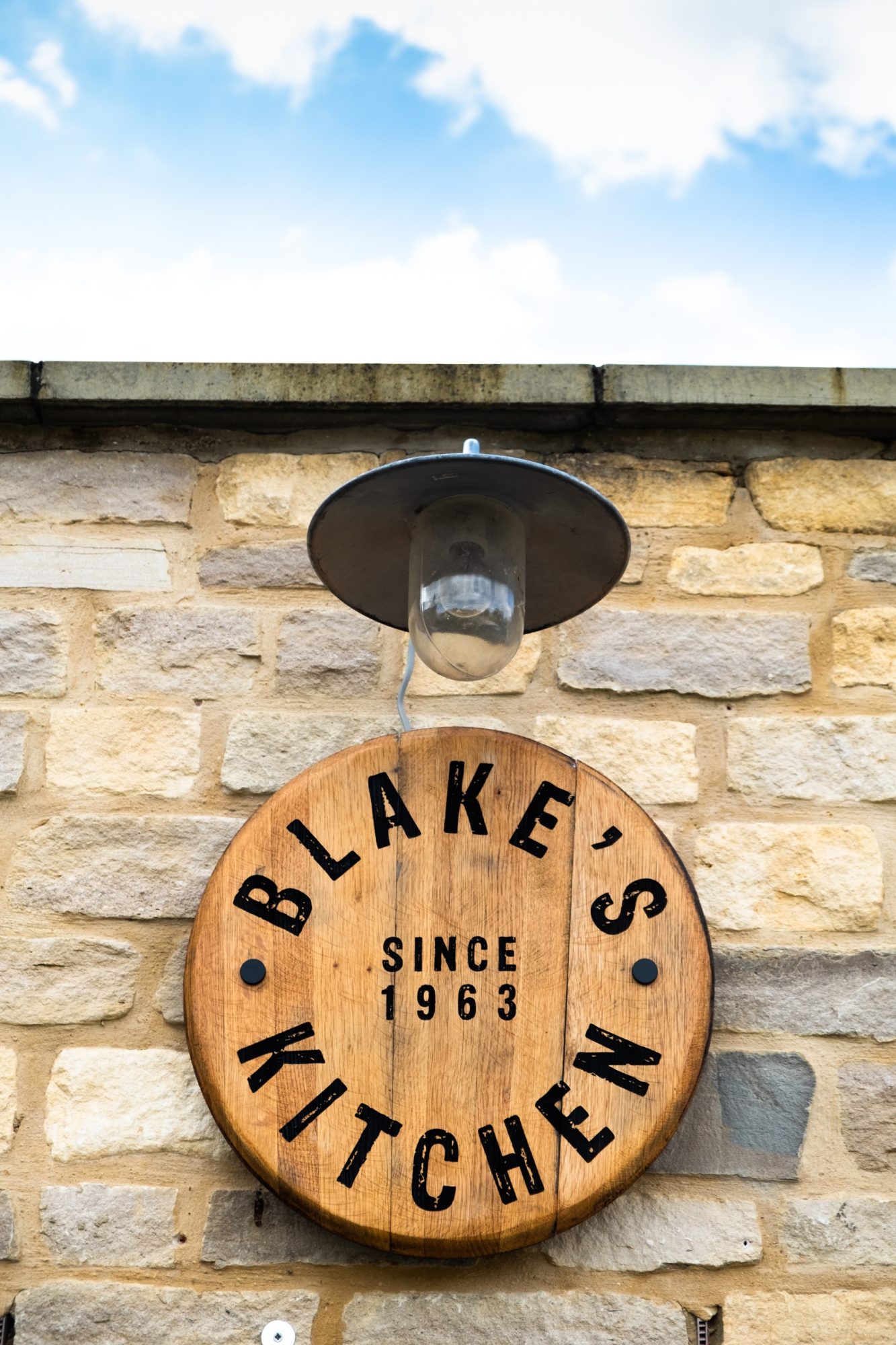 The Blake's Kitchen sign made of wood hanging on the wall