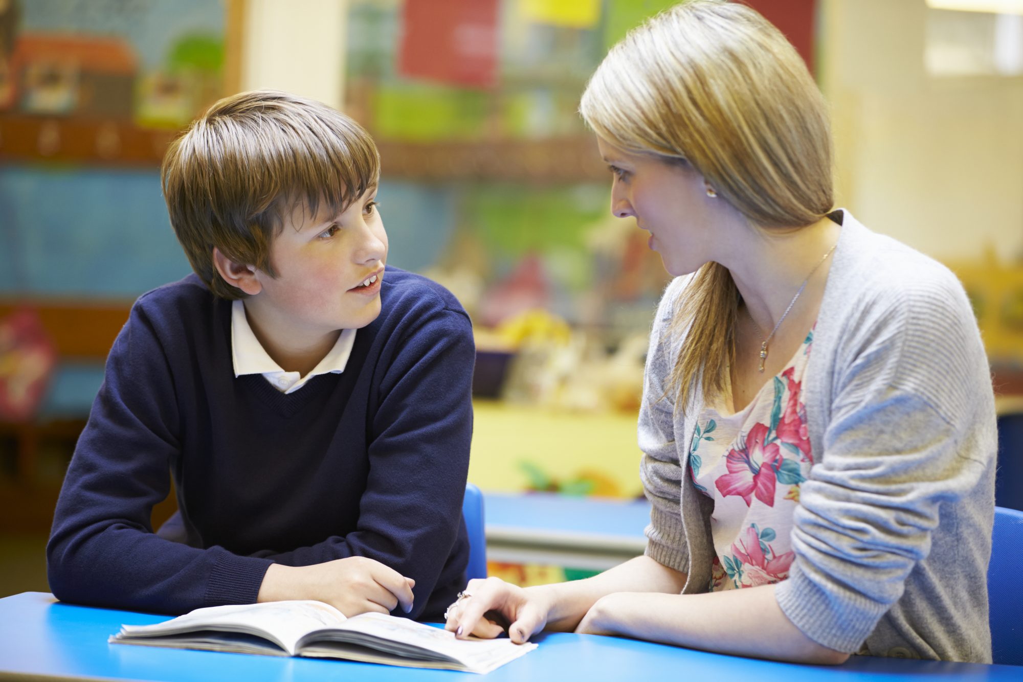 female teacher speaking to young male student